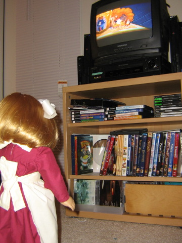 Nellie looks up at the TV, which has a picture from "Enchanted" on it.