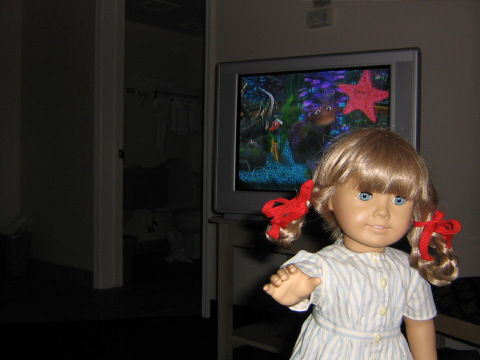 Kirsten stands up before a screen from the fish tank in the dentist's office in Finding Nemo.