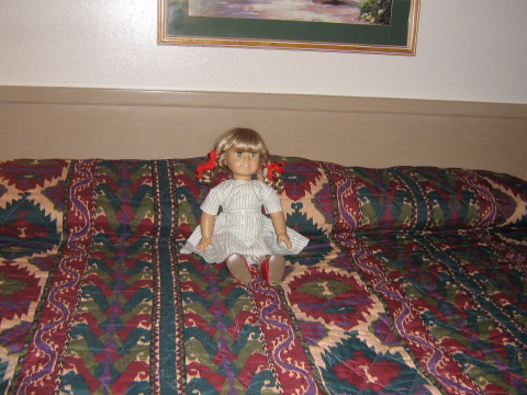 Kirsten sitting up on the bed.