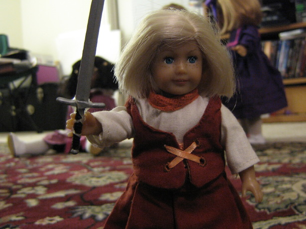 Mini Kit wears her new outfit and carries her sword.