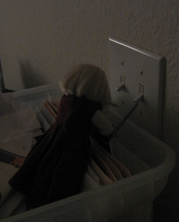 Mini Kit uses her sword to flip the light switch.