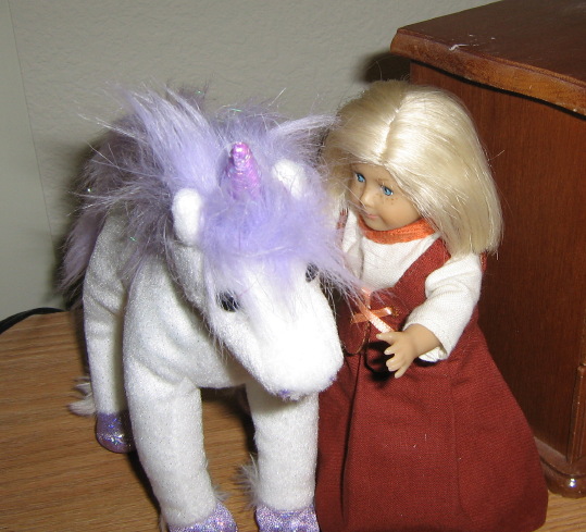 Mini Kit pets the white unicorn.