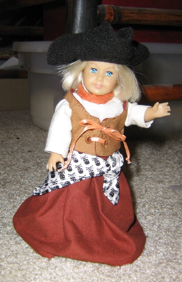 Mini Kit wears her hat with a skull and crossbones scarf tied around her waist