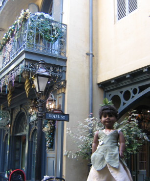 May in front of a sign that says Royal St in New Orleans Square