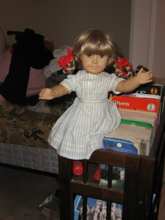 Kirsten sits on a bookshelf in the hallway.